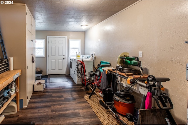 washroom with crown molding, dark wood-type flooring, and washer and dryer