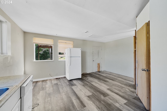 kitchen featuring white cabinetry, white appliances, and light hardwood / wood-style flooring