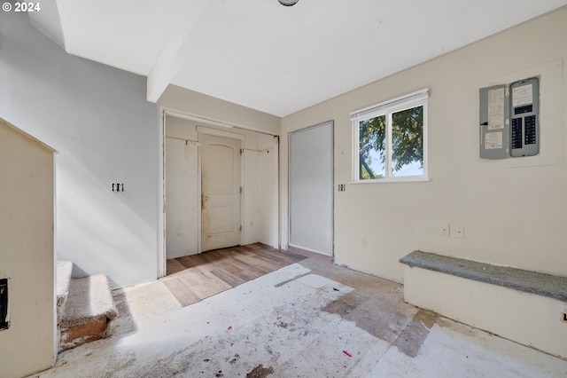 entryway with beam ceiling and electric panel