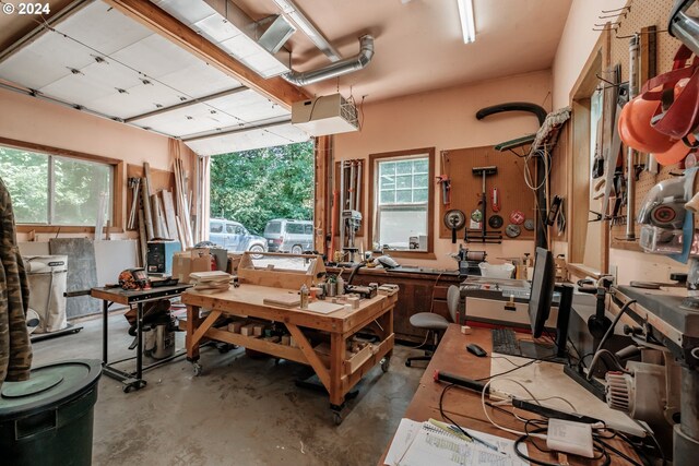 misc room with concrete flooring, a workshop area, and a healthy amount of sunlight