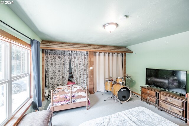 bedroom with lofted ceiling and light colored carpet