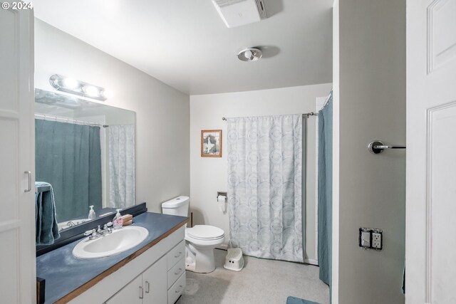 bathroom featuring toilet and vanity