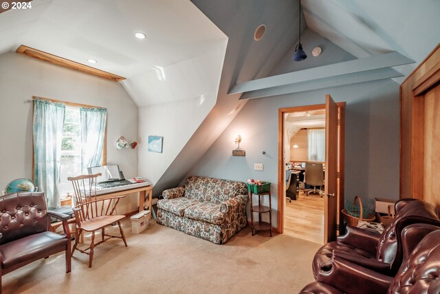 interior space with light carpet and vaulted ceiling