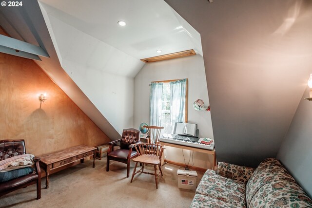 sitting room with vaulted ceiling and light carpet