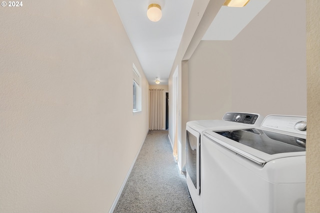 washroom with washing machine and clothes dryer and light colored carpet