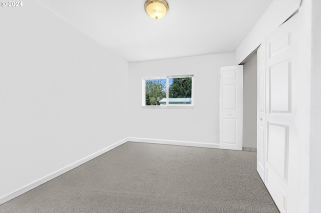 unfurnished bedroom with carpet and a closet