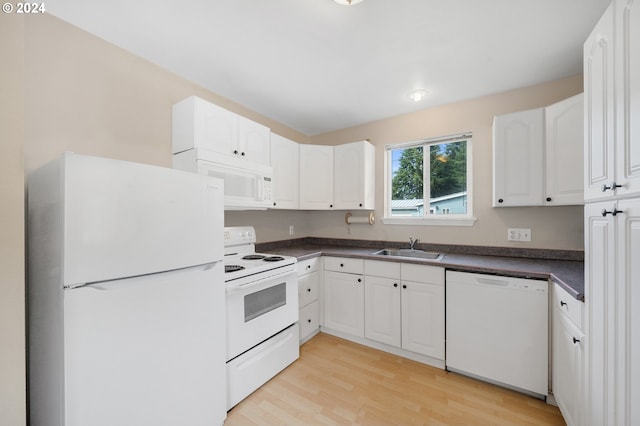 kitchen with light wood-type flooring, white cabinets, white appliances, and sink