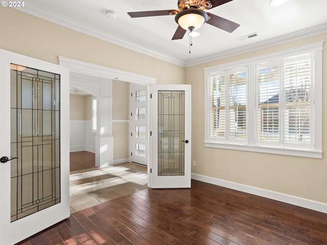 entrance foyer featuring arched walkways, dark wood-type flooring, visible vents, french doors, and ornamental molding