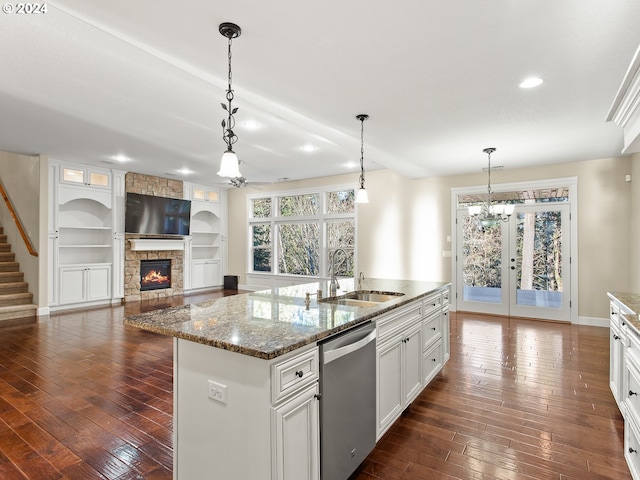 kitchen with white cabinetry, a sink, an island with sink, and stainless steel dishwasher