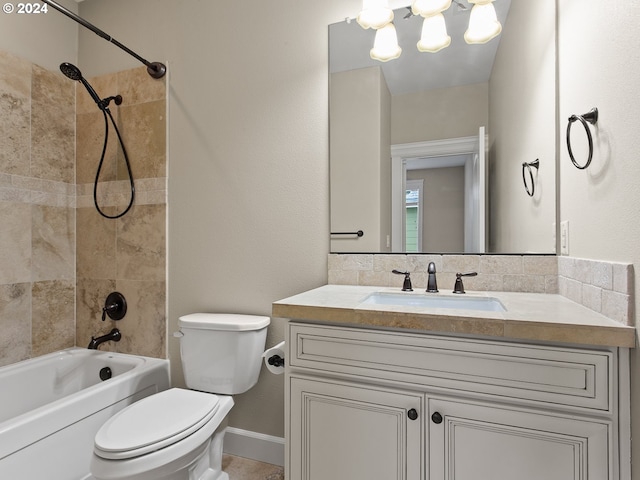 bathroom with toilet, washtub / shower combination, baseboards, and vanity