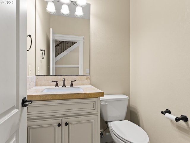 bathroom with toilet and vanity