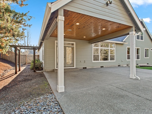 back of property with crawl space, fence, a pergola, and a patio