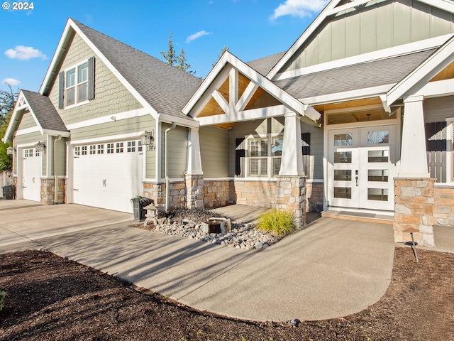 craftsman house with board and batten siding, concrete driveway, a shingled roof, and stone siding