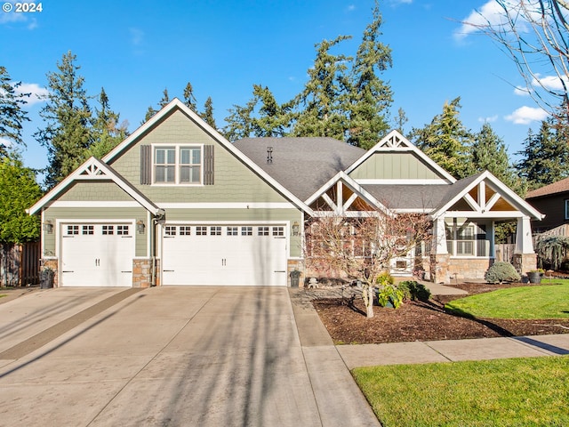 craftsman inspired home with board and batten siding, stone siding, driveway, and a front lawn