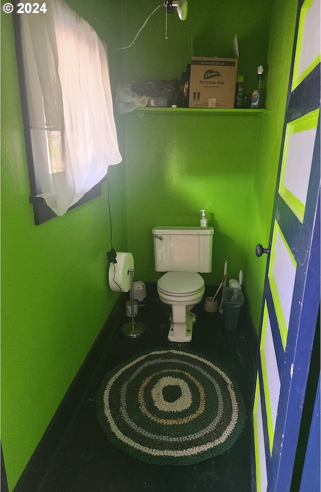 half bathroom featuring toilet