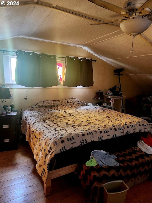 bedroom featuring vaulted ceiling and wood-type flooring