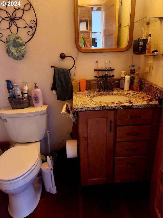 half bathroom with toilet and vanity