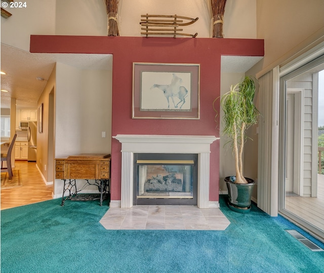 300 Spinnaker Way, Columbia City, OR 97018 - carpeted living room featuring a multi sided fireplace and baseboards