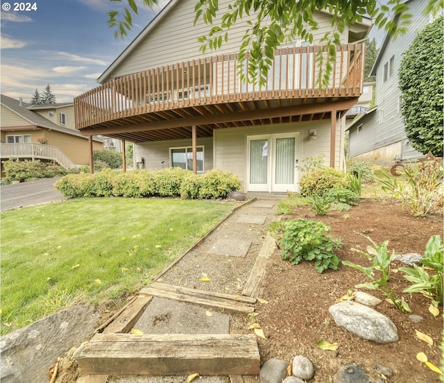 view of front of home with a wooden deck and a front lawn