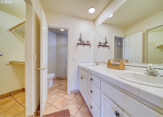 300 Spinnaker Way, Columbia City, OR 97018 - bathroom with double vanity, toilet, tile patterned flooring, and a spacious closet