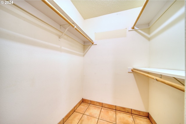 spacious closet with light tile patterned floors