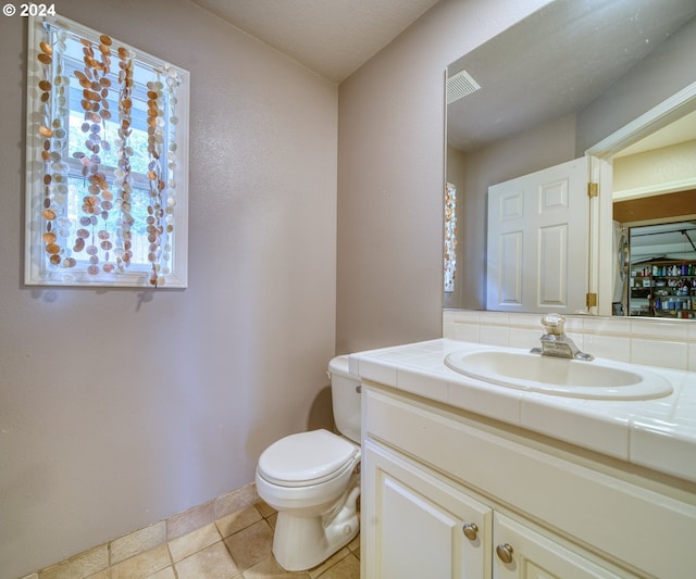 bathroom with tile patterned floors, vanity, and toilet