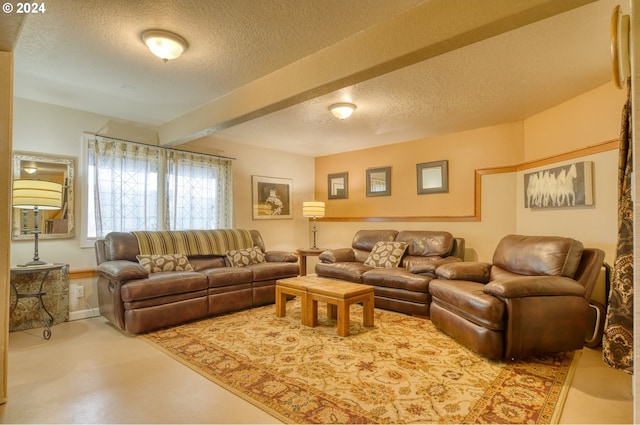 living room featuring beamed ceiling, concrete floors, and a textured ceiling