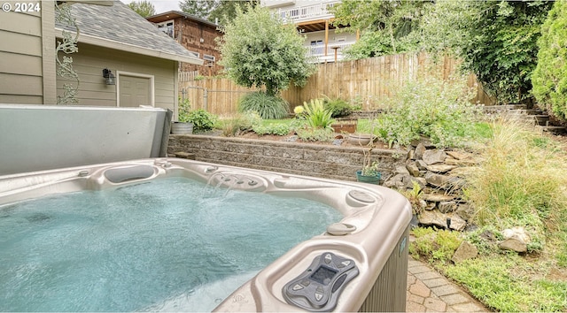 view of swimming pool with a hot tub