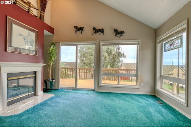 unfurnished living room with carpet floors and vaulted ceiling