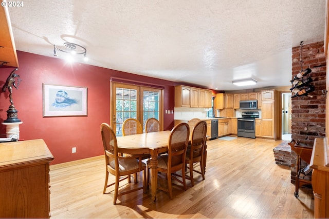 8805 NE 36th St, Vancouver, WA 98662 - dining room with baseboards, a textured ceiling, and light wood-style floors
