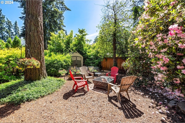 8805 NE 36th St, Vancouver, WA 98662 - view of yard featuring an outbuilding, an outdoor fire pit, a storage unit, and fence