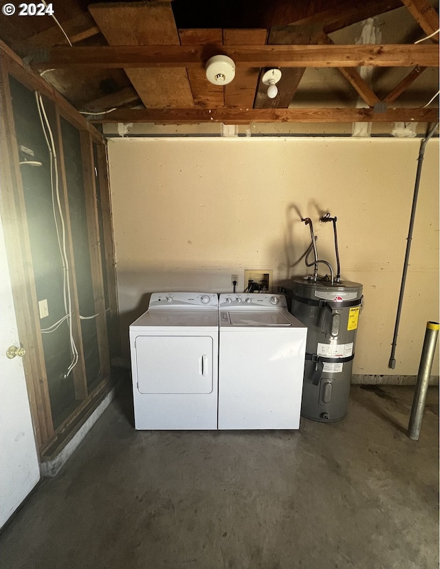 clothes washing area with washing machine and clothes dryer and water heater