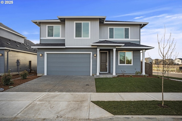 view of front of home with driveway, a front lawn, a garage, and roof with shingles