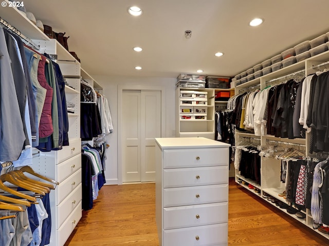 walk in closet with light wood-style floors