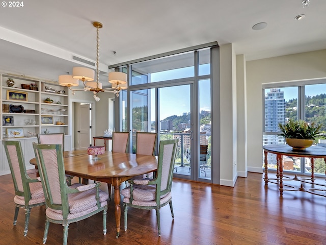 dining area with a chandelier, dark wood-style flooring, visible vents, and floor to ceiling windows