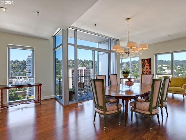 dining area featuring a healthy amount of sunlight, a chandelier, and dark hardwood / wood-style floors