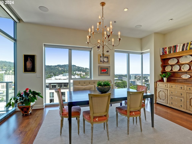 dining room featuring an inviting chandelier, hardwood / wood-style flooring, and a wealth of natural light