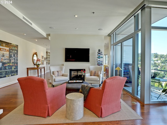 living room featuring visible vents, a wall of windows, wood finished floors, and recessed lighting