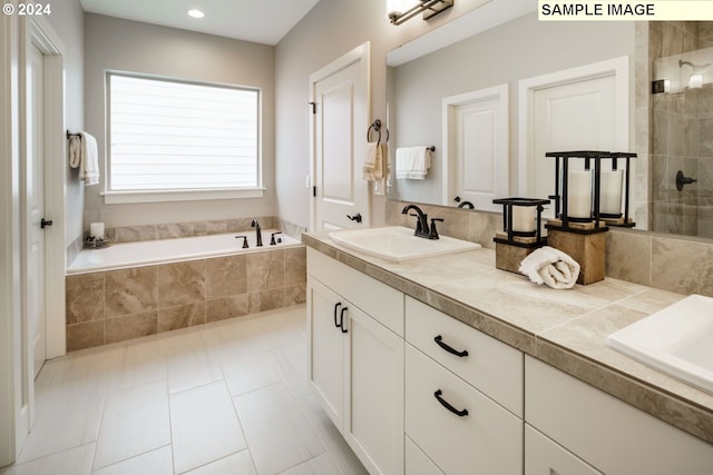 bathroom featuring tile patterned floors, vanity, and shower with separate bathtub