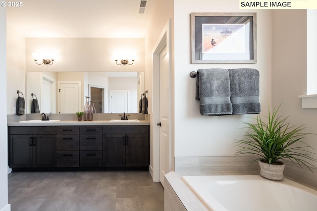 bathroom featuring vanity and a relaxing tiled tub