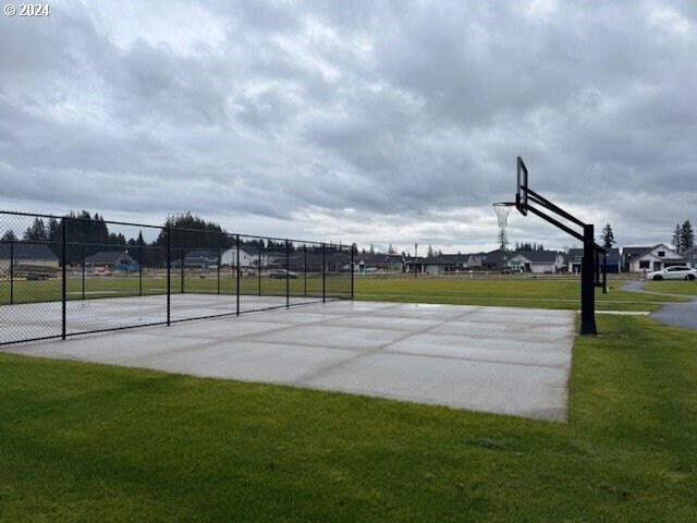 view of basketball court featuring a lawn