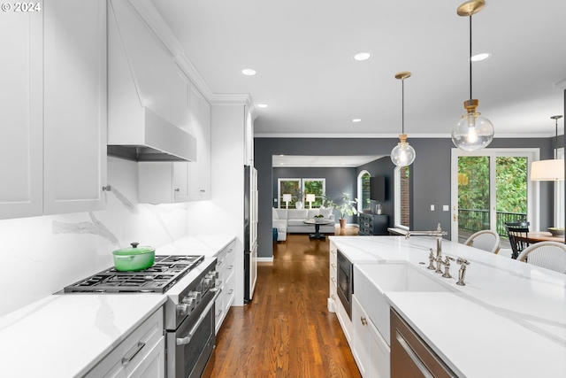 kitchen with pendant lighting, white cabinetry, and high quality appliances