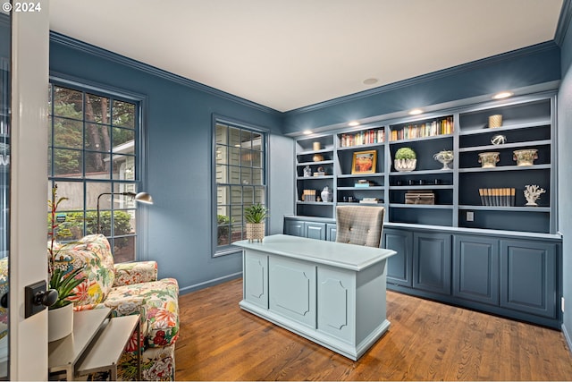 office space featuring crown molding, wood-type flooring, and plenty of natural light