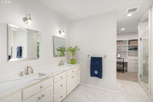 bathroom with vanity and a shower with shower door