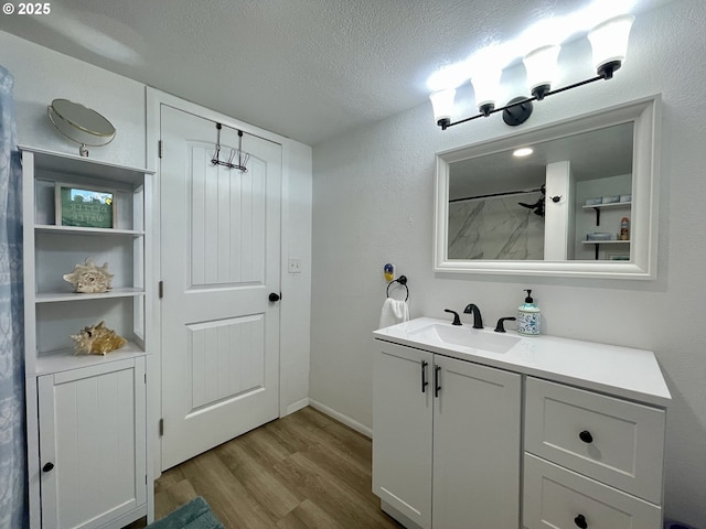 665 Clearlake Ave, Winchester Bay, OR 97467 - full bathroom featuring vanity, wood finished floors, and a textured ceiling