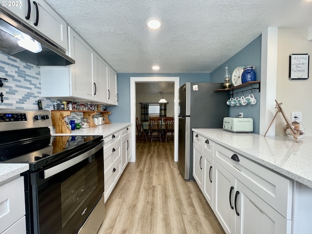 kitchen featuring light wood-style flooring, backsplash, stainless steel range with electric cooktop, white cabinetry, and under cabinet range hood