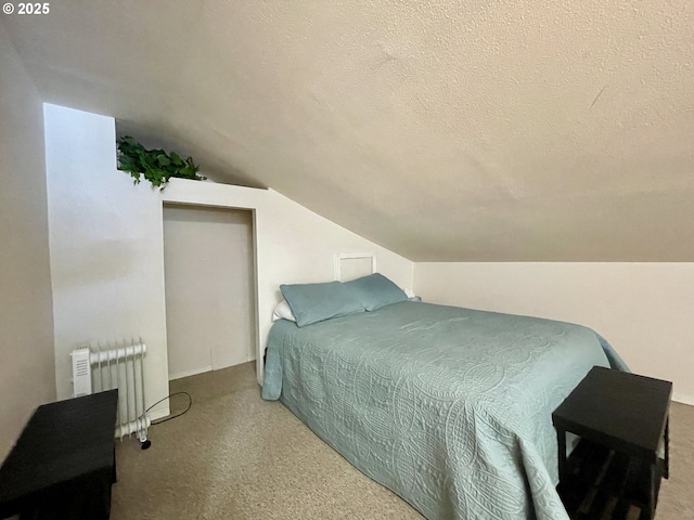 carpeted bedroom with a textured ceiling, radiator heating unit, and vaulted ceiling