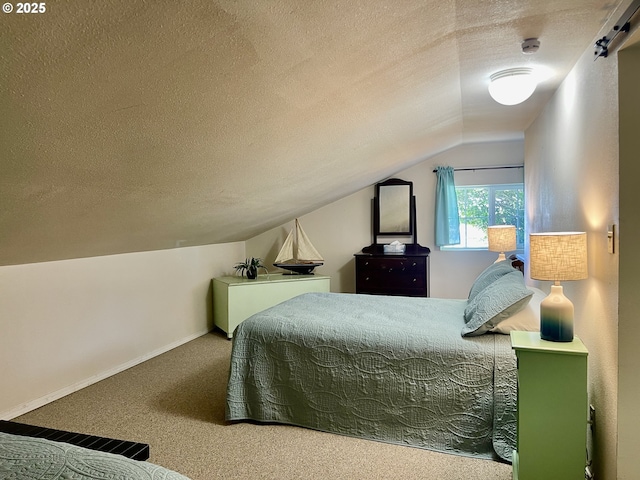 carpeted bedroom featuring lofted ceiling, baseboards, and a textured ceiling