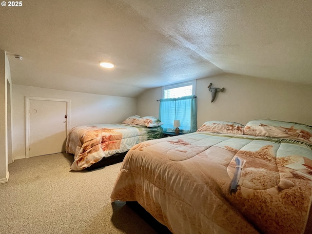 bedroom featuring carpet floors, vaulted ceiling, and a textured ceiling