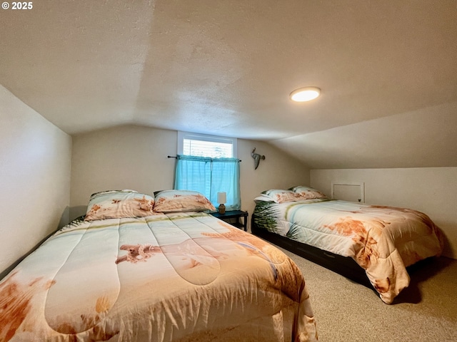 carpeted bedroom with lofted ceiling and a textured ceiling